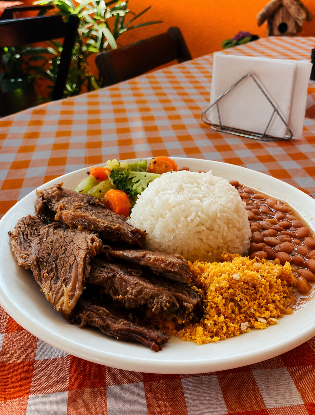 Prato caseiro com arroz, feijão, carne, farofa e legumes